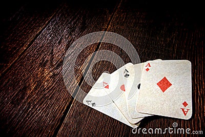 Four Aces Vintage Poker Cards on Old Saloon Table