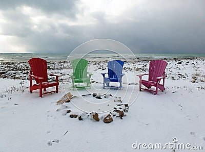 Four Colorful Chairs on a Winter Beach
