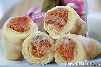 Four delecious rolled cakes and milk
