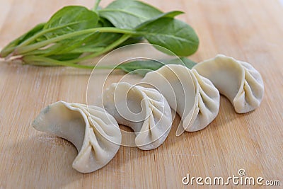 Four dumplings and spinach