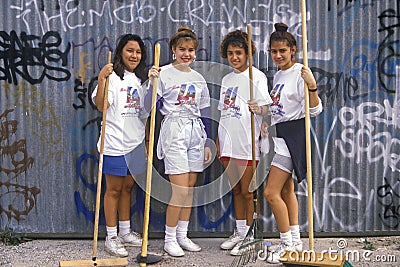 Four girls participating in community cleanup