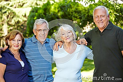 Four happy senior people in nature