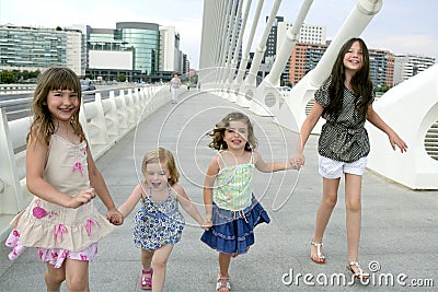 Four little girl group walking in the city