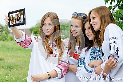 Four pretty teen girls taking picture of themselves