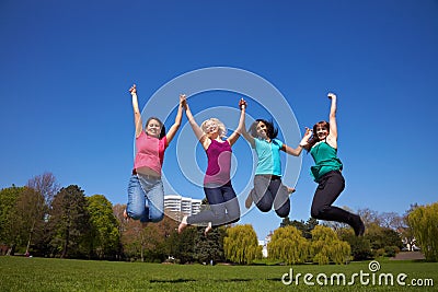 Four women jumping in the air