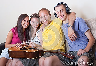 Four young people with guitar and headphones