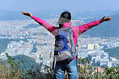 Free woman hiker mountain peak