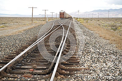 Freight train on tracks crossing desert, NV, US