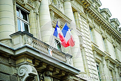 French building entrance beautiful wood door in Paris with the flag of France