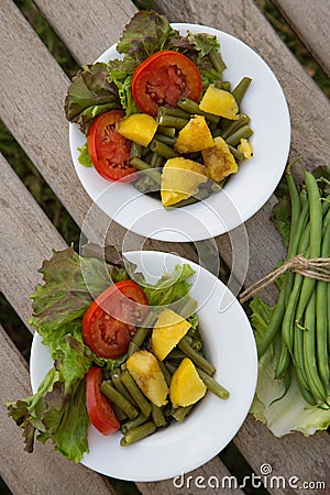 French string bean salad in white dishes