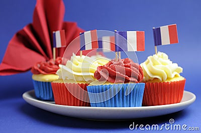 French theme red, white and blue mini cupcake cakes with flags of France - close up.