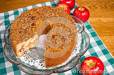 Fresh apple cake and red apples with slice missing