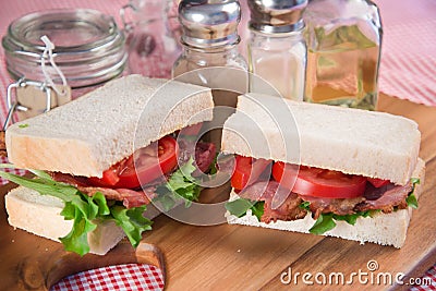 Fresh BLT on white sandwich in rustic kitchen setting