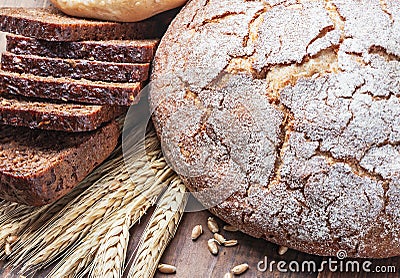 Fresh bread and rolls with ears of wheat