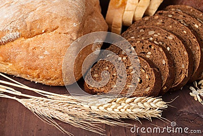 Fresh bread and wheat on the wooden.