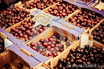 Fresh cherries in box at a farmers market