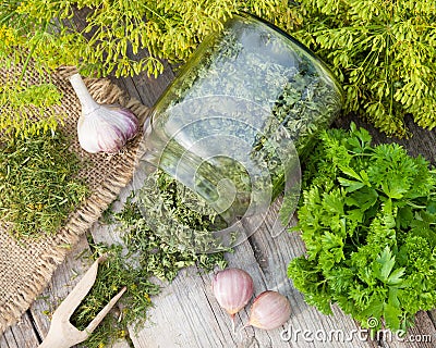 Fresh and dried chopped dill and parsley leaves on wooden rustic