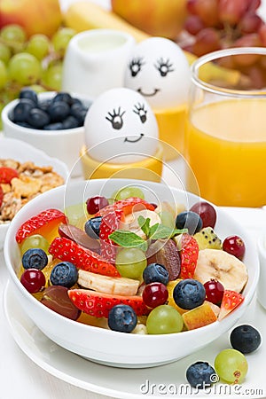 Fresh fruit salad, cream, painted eggs for breakfast