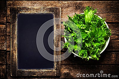 Fresh green Lettuce Salad on blank vintage slate chalk board on
