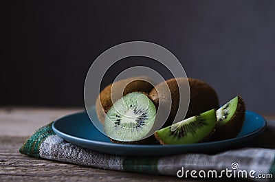 Fresh kiwi on a blue plate