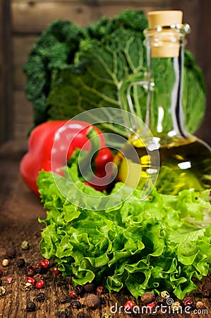 Fresh lettuce leaves , olive oil and vegetables