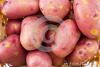 Fresh potatoes in basket isolated on white