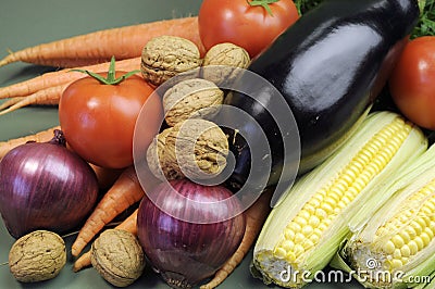 Fresh raw food including eggplant, walnuts nuts carrots tomotoes and corn for healthy diet concept