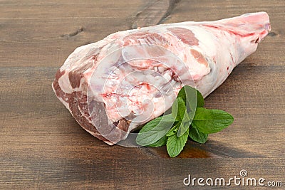 Fresh raw leg of lamb with mint leaves