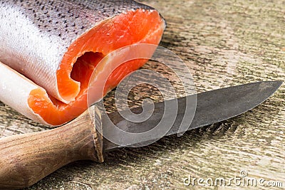 Fresh Salmon on wooden board with knife