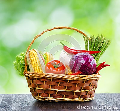 Fresh vegetables in the basket on wooden table