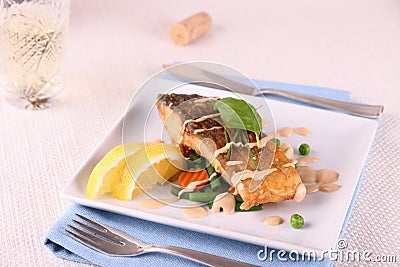 Fried carp fish fillet with vegetables, wine