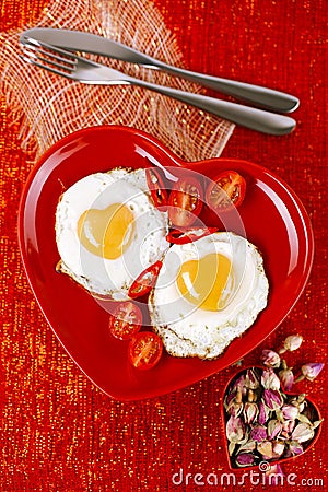 Fried egg with heart shape yolks and rose tea