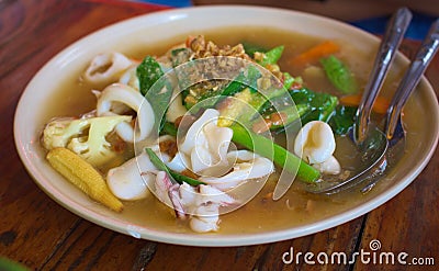 Fried noodles with squid and kale in gravy sauce