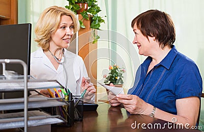 Friendly doctor consulting female patient