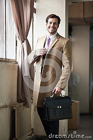 Friendly and smiling businessman looking at camera
