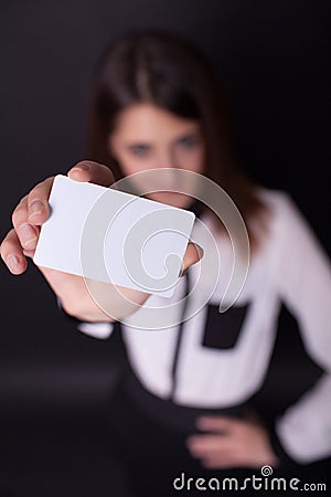 Friendly woman holding a business card and smiling