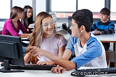 Friends Looking At Each Other While Using Computer