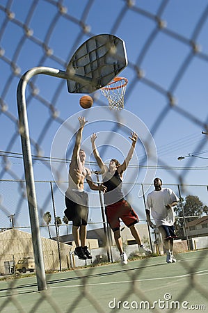 Friends Playing Basketball On Court