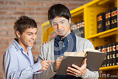 Friends Reading Book In College Library