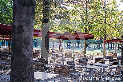 Friends sit at a cafe table in the Tuileries, Paris, France