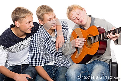 Friends spend leisure time playing the guitar