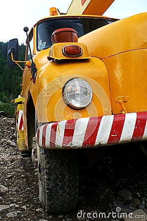 Front detail of older orange construction crane truck