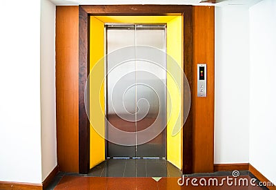 Front view of a modern elevator with closed doors in lobby