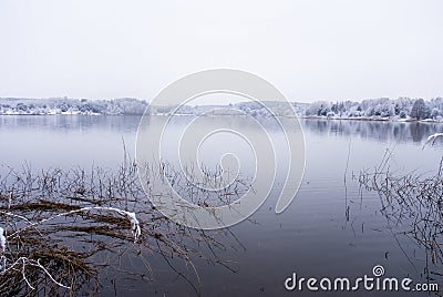 Frozen thawing lake in snow landscape