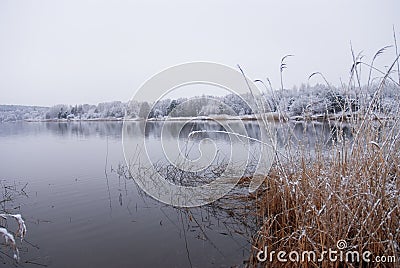 Frozen thawing lake in snow landscape
