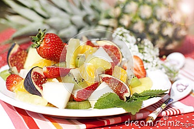 Fruit salad on the background of fresh pineapple