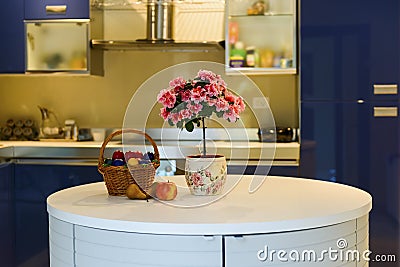 Fruits and flowers in blue interior kitchen