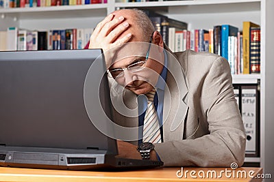 Frustrated man with laptop