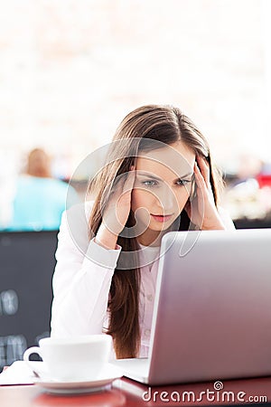 Frustrated woman working on her laptop
