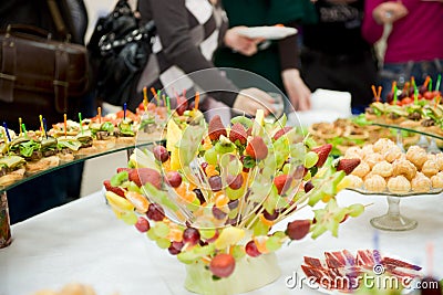 Full banquet table, eating people in background